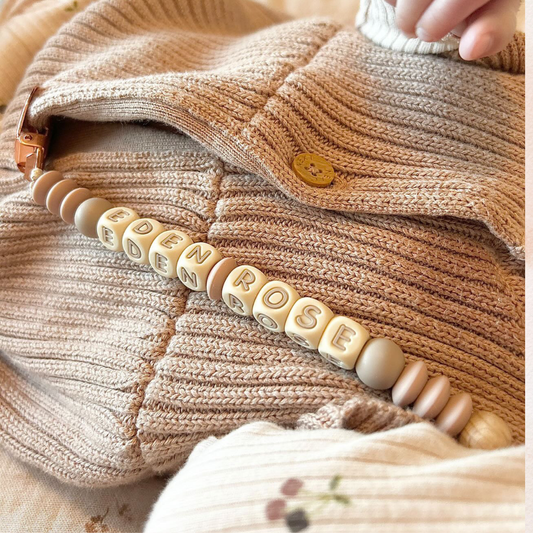 personalised silicone dummy clip with baby name by Baebea